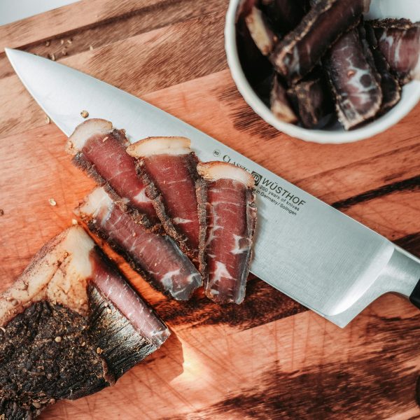 Biltong being sliced into thin pieces
